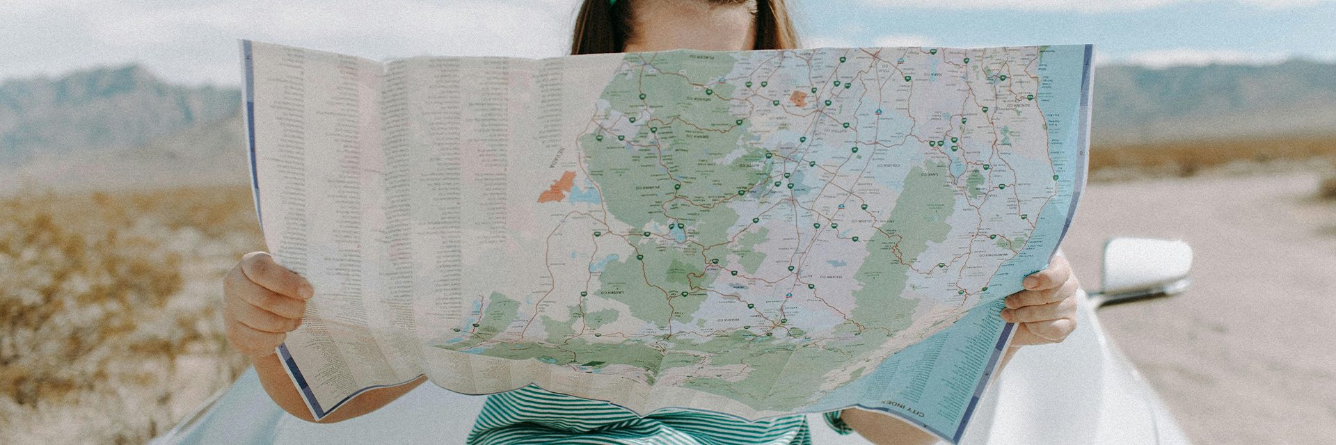 Woman with Road Map – Summer Road Trip Woman holding a road map, symbolising a summer road trip.